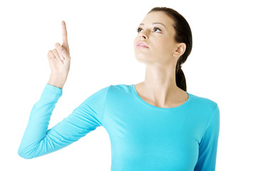 Happy , excited young woman pointing on copy space