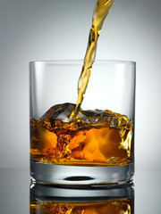 Pouring Scotch Whisky in Glass with perfect ice