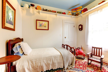 Classic antique American baby boy room with old toys.