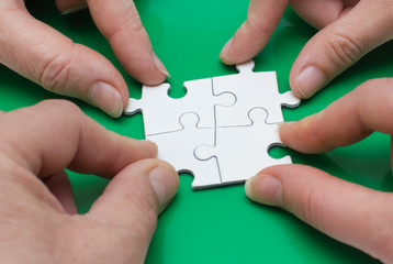 Four people with puzzle