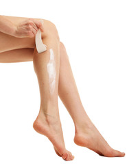 Beautiful woman legs with depilation cream, isolated on white