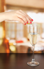 Pour something into glass with drink