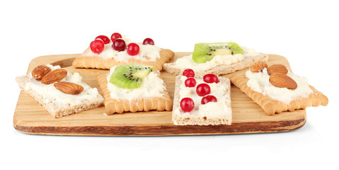 Tasty canapes with cheese, kiwi and cranberry, almond,