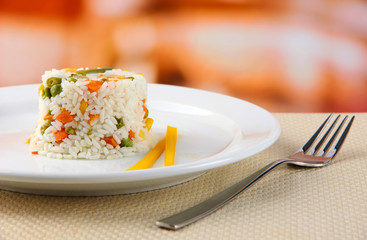 Delicious risotto with vegetables on table in cafe