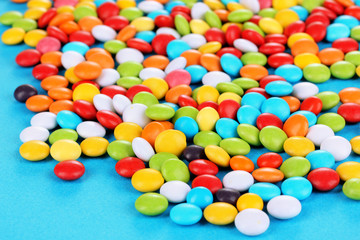 Fototapeta na wymiar Colorful candies on blue background
