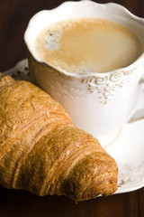 breakfast with cup of black coffee and croissants
