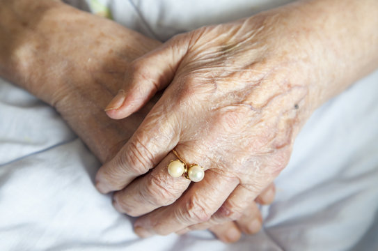 Hands of elderly lady with golden ring-series of photos