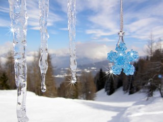 Icicles with blue crystal beads star in the mountains