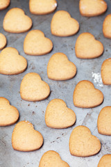 Home made heart shaped cookies on baking tray