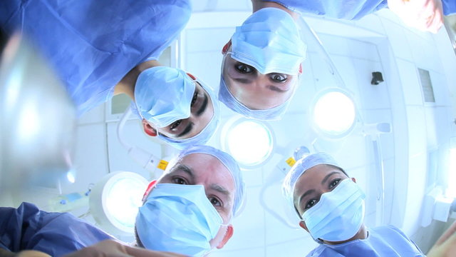 Surgical Team in Operating Theater Faces Hands Close Up