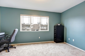Simple home office room interior with blue walls.