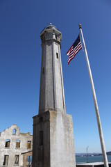 Obraz premium Tower and USA flag at Alcatraz Island, USA