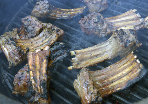 Rack of lamb frying on grill