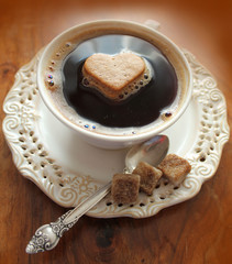 Coffee cup with heart on a wooden table