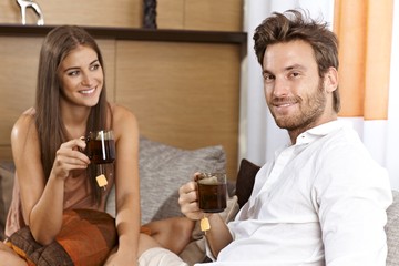 Attractive couple having tea at home