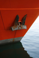 One black anchor on red ship