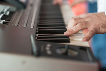 Musician playing on keyboards.Hands playing 