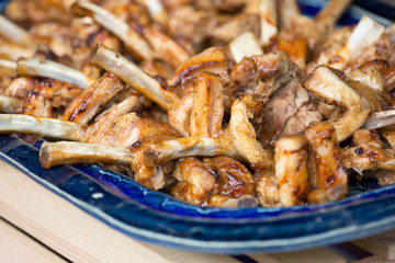 Delicious roasted pork chobs on a blue plate