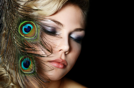 The beautiful woman with feathers of a peacock