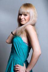 Portrait of a beautiful blonde in a blue dress