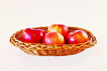 Apples in wicker bowl.
