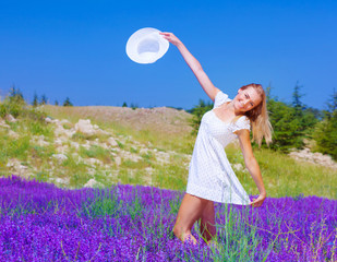 Cute girl dancing on lavender field