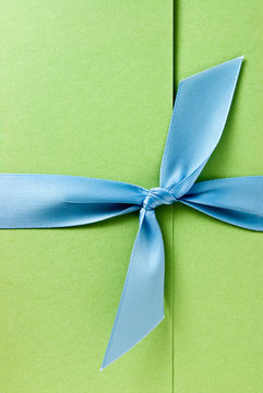 Green Invitation Tied With A Blue Bow