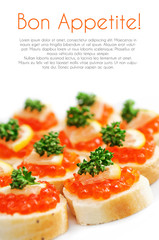 Canapes with salmon caviar, lemon and parsley