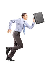 Full length portrait of a businessman running with a briefcase