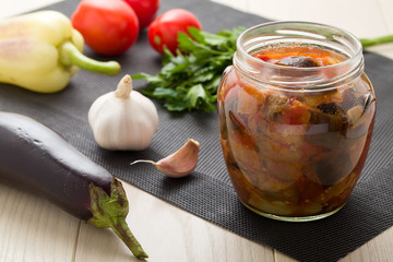 Cooked stewed eggplants prepared for canning with raw vegetables