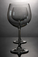 Empty wine glasses arranged on grey background