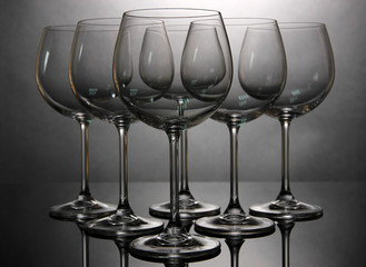 Empty wine glasses arranged on grey background