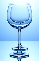 Empty wine glasses arranged on blue background