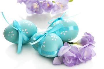 Bright easter eggs with bows and flowers, isolated on white