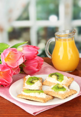 Tasty canapes with cheese and kiwi,