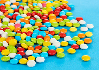 Colorful candies on blue background