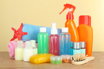 Hotel amenities kit on table on beige background