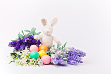 Easter rabbit colorful eggs and flowers