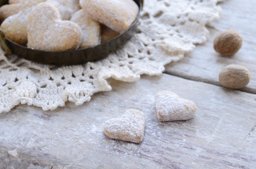 Homemade heart shaped cookies on wooden background in vintage st