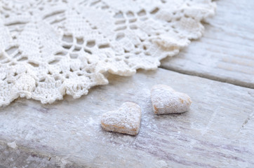 Homemade heart shaped cookies on wooden background in vintage st