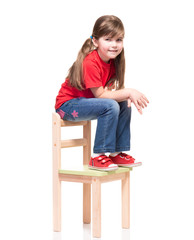 little girl wearing red t-shirt and posing on chair