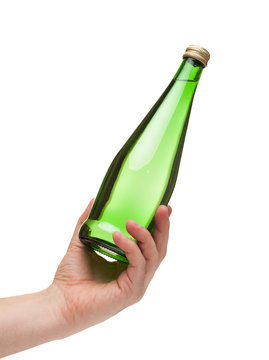 hand holding a green transparent bottle