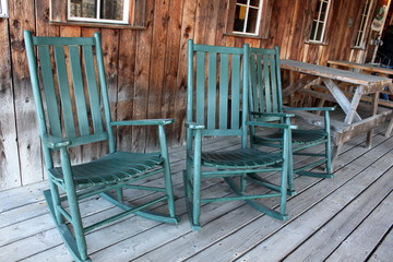 Three green rocking chairs