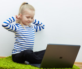 Kid girl using laptop