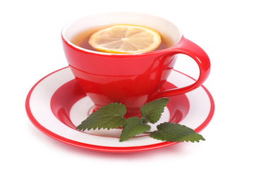 Tea with lemon and mint in a red cup and saucer isolated