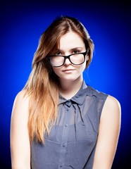 Fototapeta premium Young woman looking through the nerd glasses