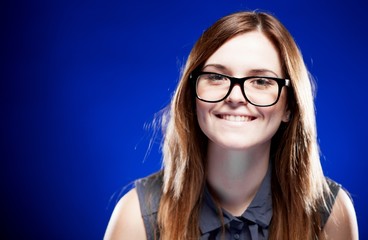 Fototapeta premium Young woman with lovely smile and nerd glasses
