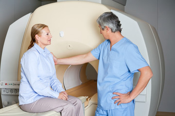 Technician Comforting Female Patient