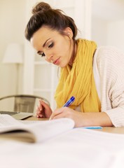 Indoor Woman Studying at Home Writing Something