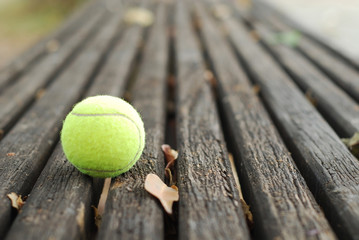 tennis balls on wood floor - obrazy, fototapety, plakaty